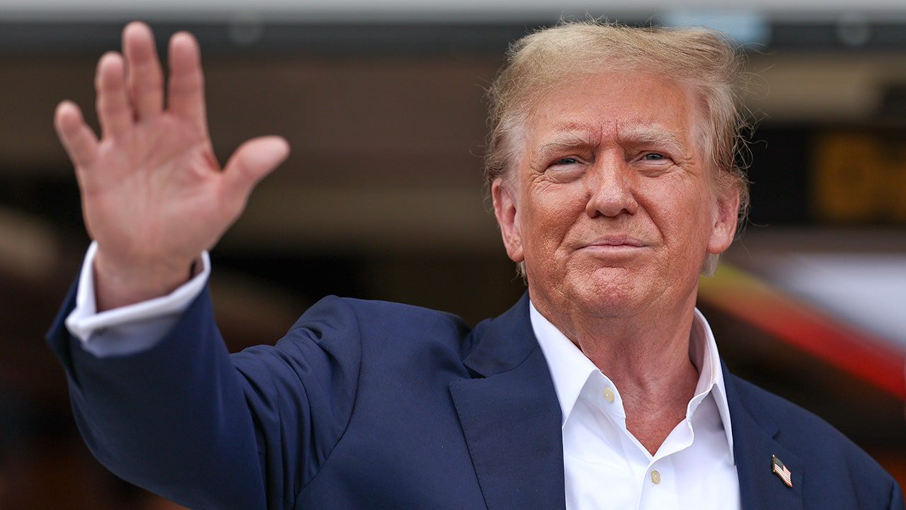 Donald Trump waves to crowd, salutes during national anthem at F1 Miami ...