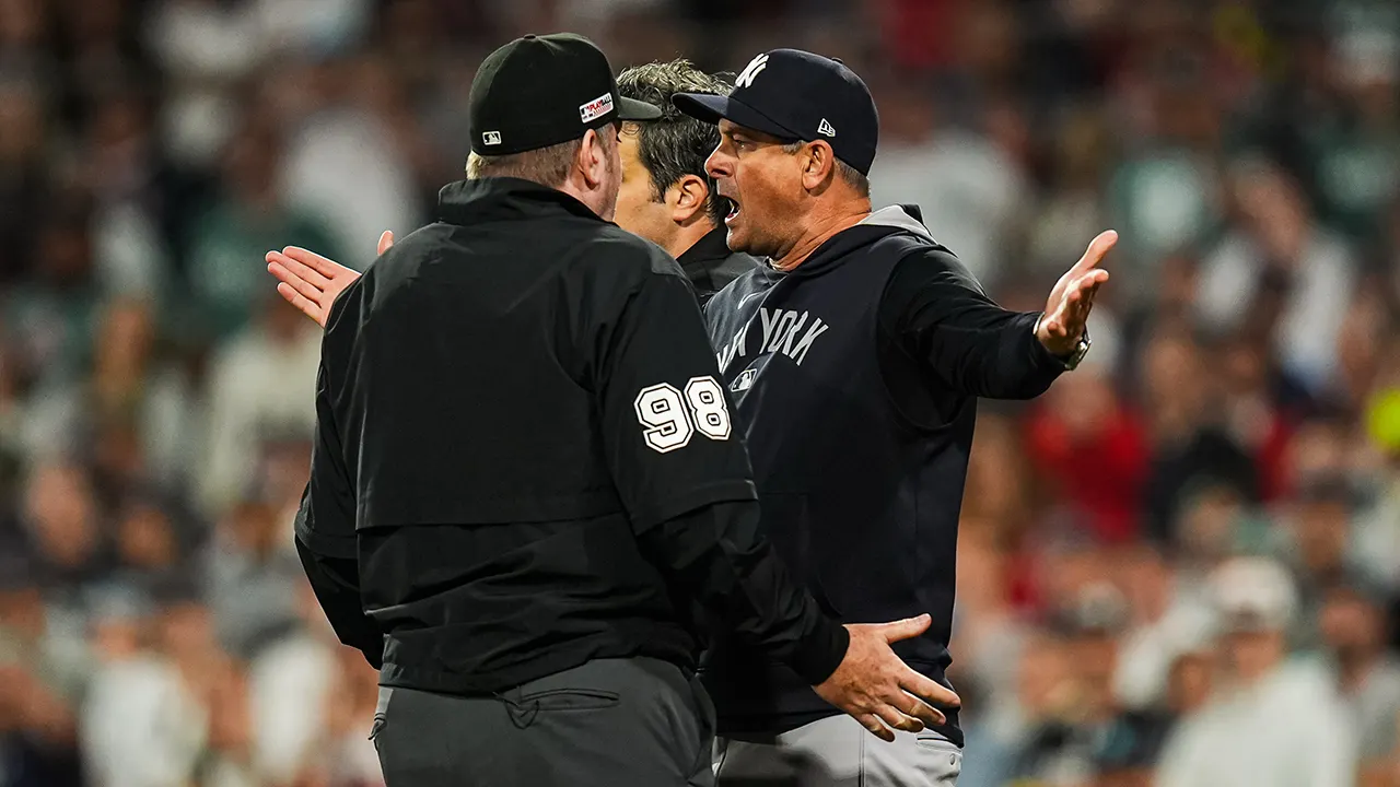Aaron Boone of the Yankees throws gum in frustration over disputed foul ball decision