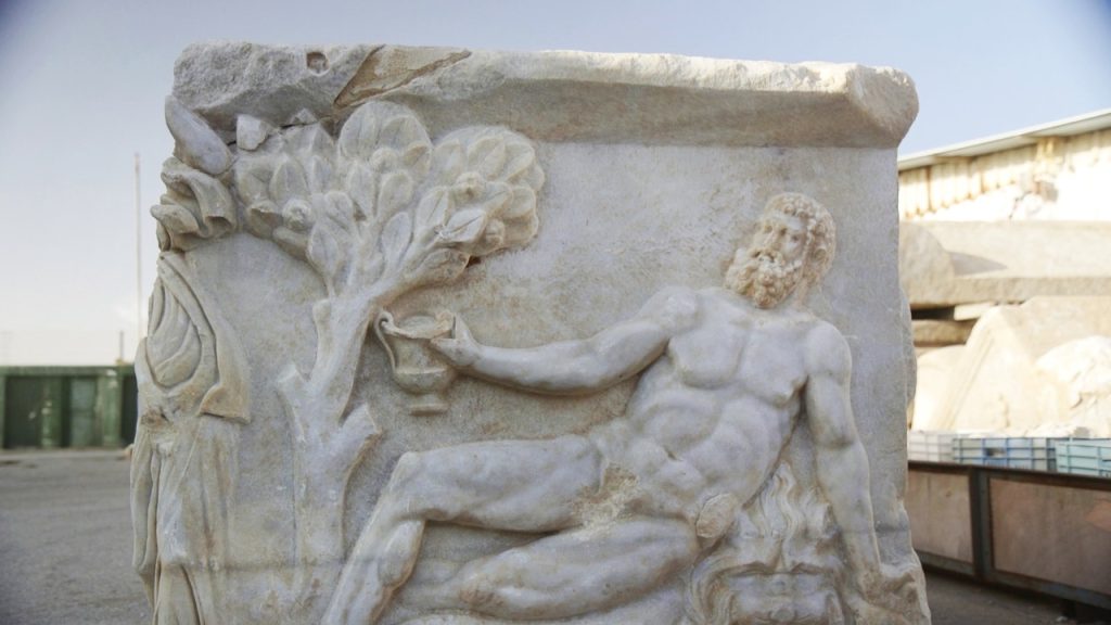 Ancient sarcophagus depicting Dionysus and Hercules playing a drinking game discovered in Israel