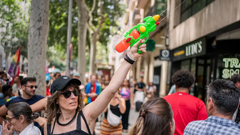 Barcelona residents use water guns to demonstrate against tourists due to overtourism issues.