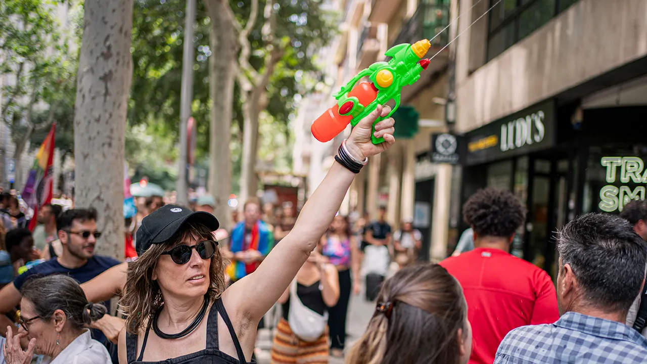 Barcelona residents use water guns to demonstrate against tourists due to overtourism issues.
