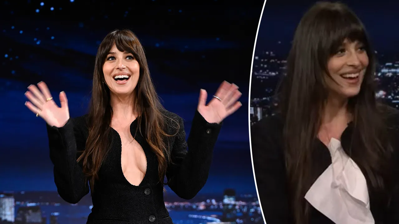 Dakota Johnson has difficulty with her revealing dress during an interview with Jimmy Fallon