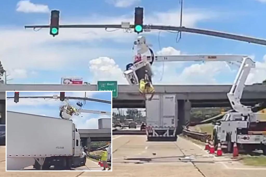 Louisiana utility worker dangles over a busy road after being hit by a truck.