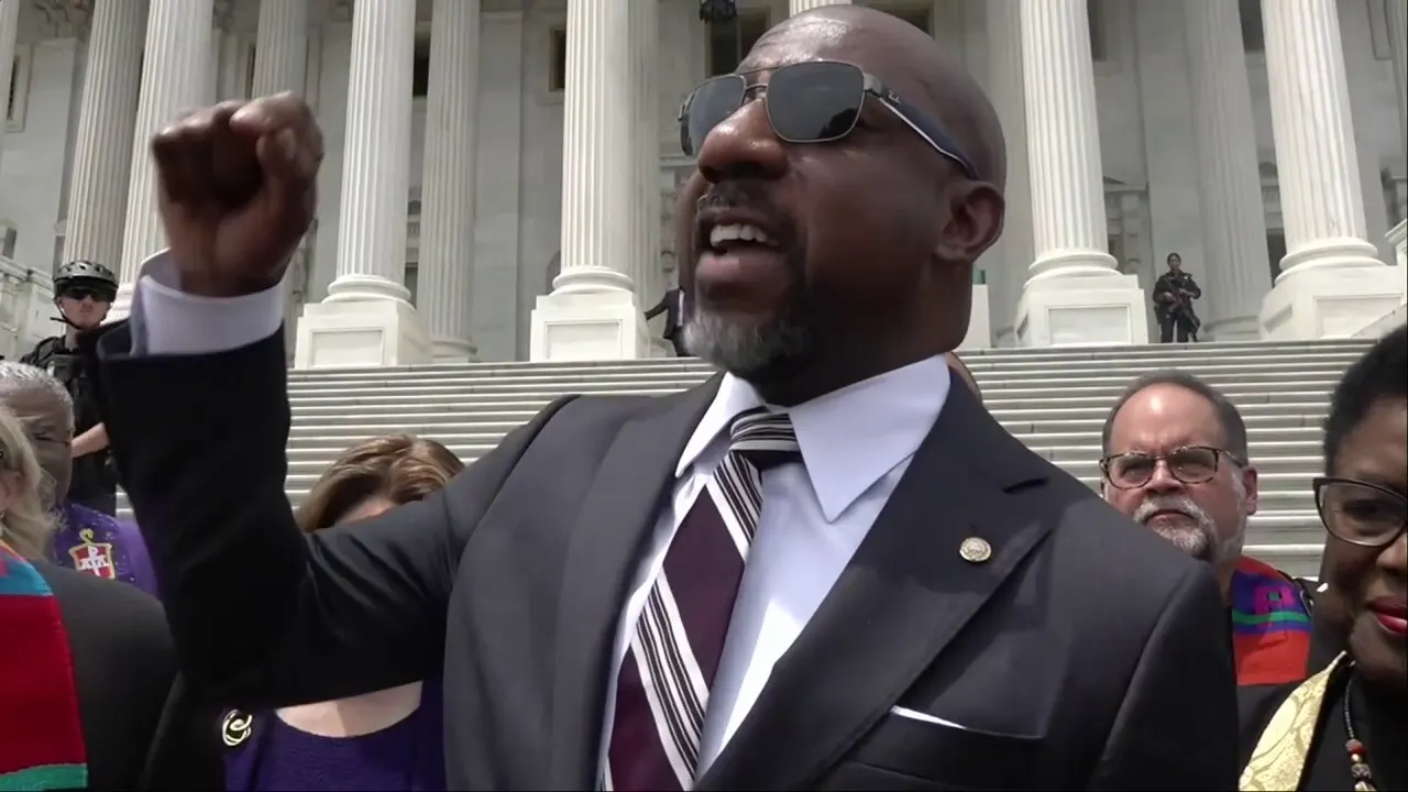 Raphael Warnock leads a prayer vigil opposing the Big Beautiful Bill