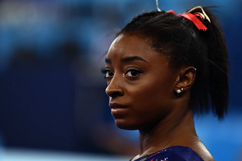 Simone Biles offers an apology for criticizing Riley Gaines regarding her stance on trans women in sports.