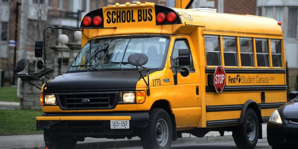 Video captures upset parents confronting a male school bus driver dressed as a 'school girl' over an allegedly troubling route name.