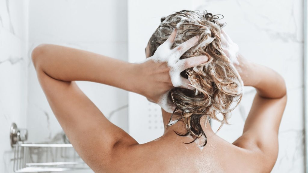 Woman criticizes hotel shower designs for inadequate guest comfort, sparking online attention.