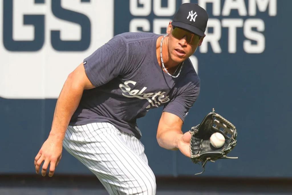 Aaron Judge practices outfield drills with Giancarlo Stanton.