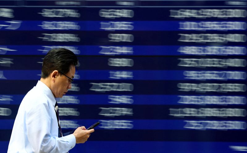 Asian stocks decline from peaks, dollar rises as markets prepare for a significant week