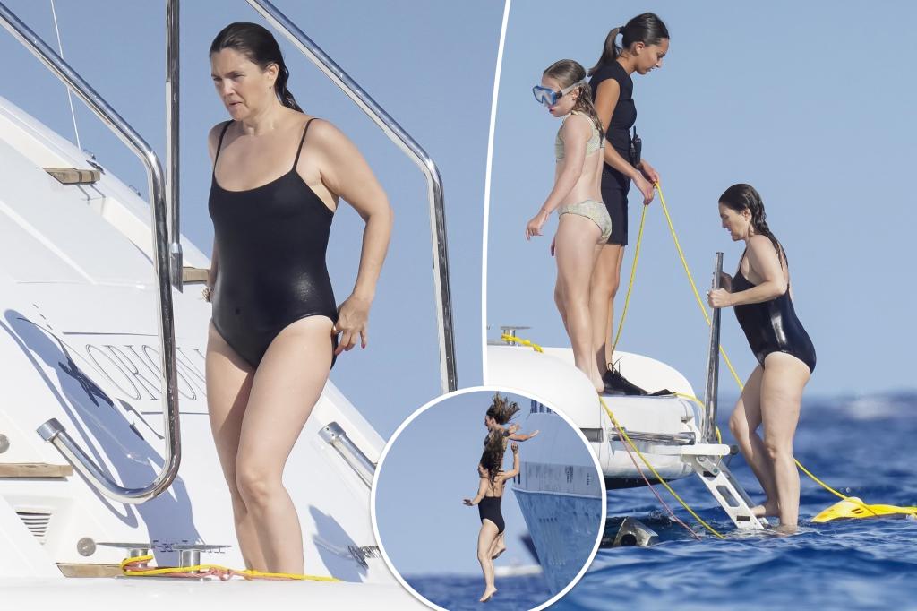 Drew Barrymore enjoys a swim in a black swimsuit on a yacht in St. Tropez