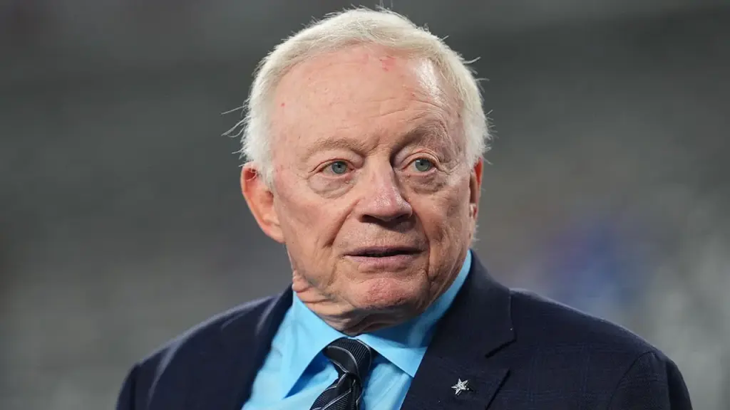 Fans of the Cowboys shout 'Pay Micah!' while Jerry Jones talks about the contract issue.