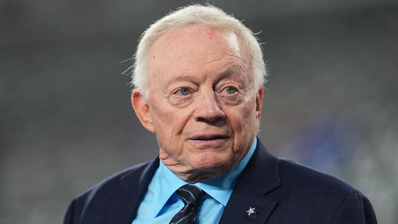 Fans of the Cowboys shout 'Pay Micah!' while Jerry Jones talks about the contract issue.