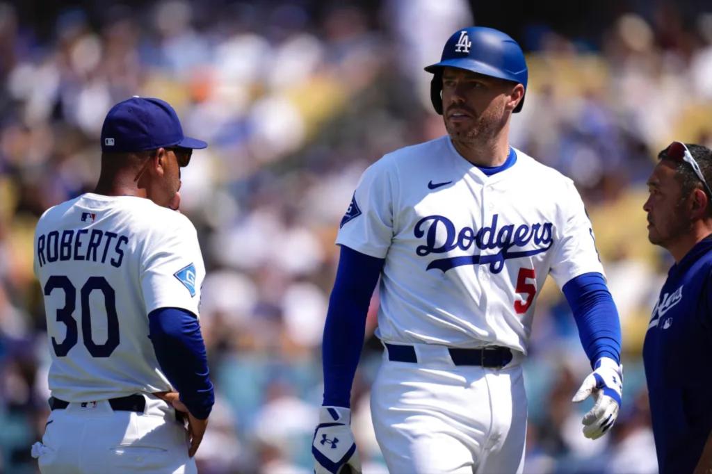 Freddie Freeman of the Dodgers leaves the game due to a wrist injury caused by being hit by a pitch