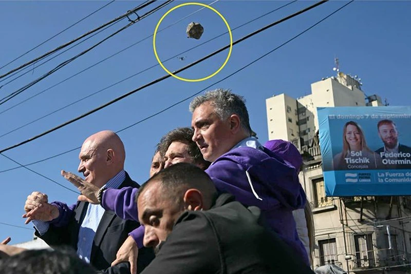 Argentina's President Milei swiftly removed by security during campaign event as protesters hurl rocks at him