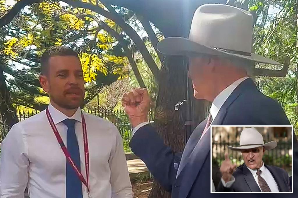 Australian politician Bob Katter warns Channel Nine reporter Josh Bavas with his fist