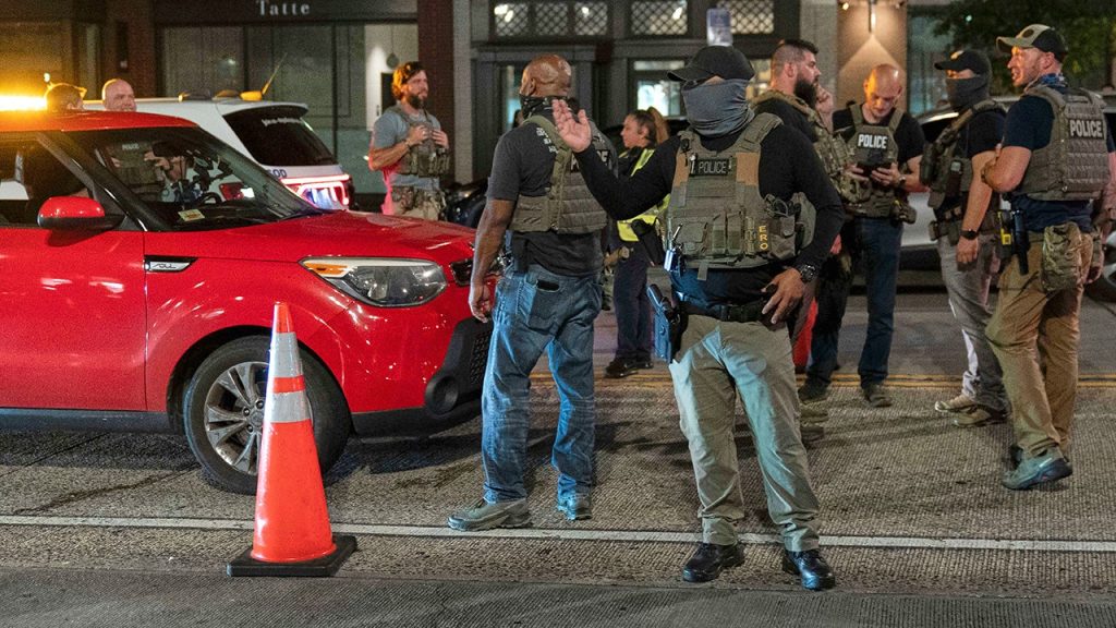 Demonstrators shout at officers during a confrontation at a checkpoint in Washington D.C.