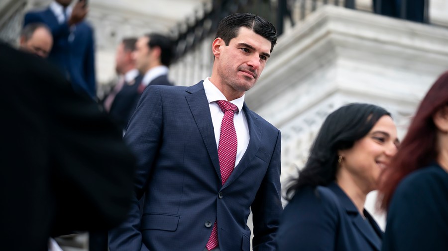 GOP congressman claims he could face financial loss if his advisers halt stock trading.