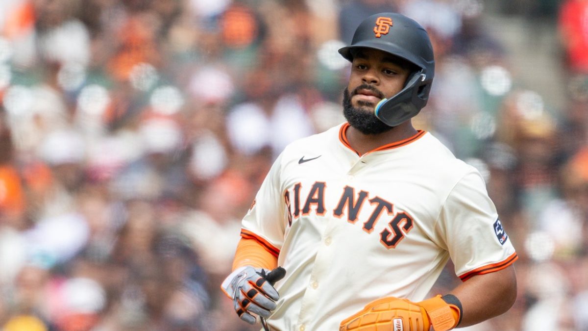 Heliot Ramos of the SF Giants makes an odd throw in the outfield against the Padres