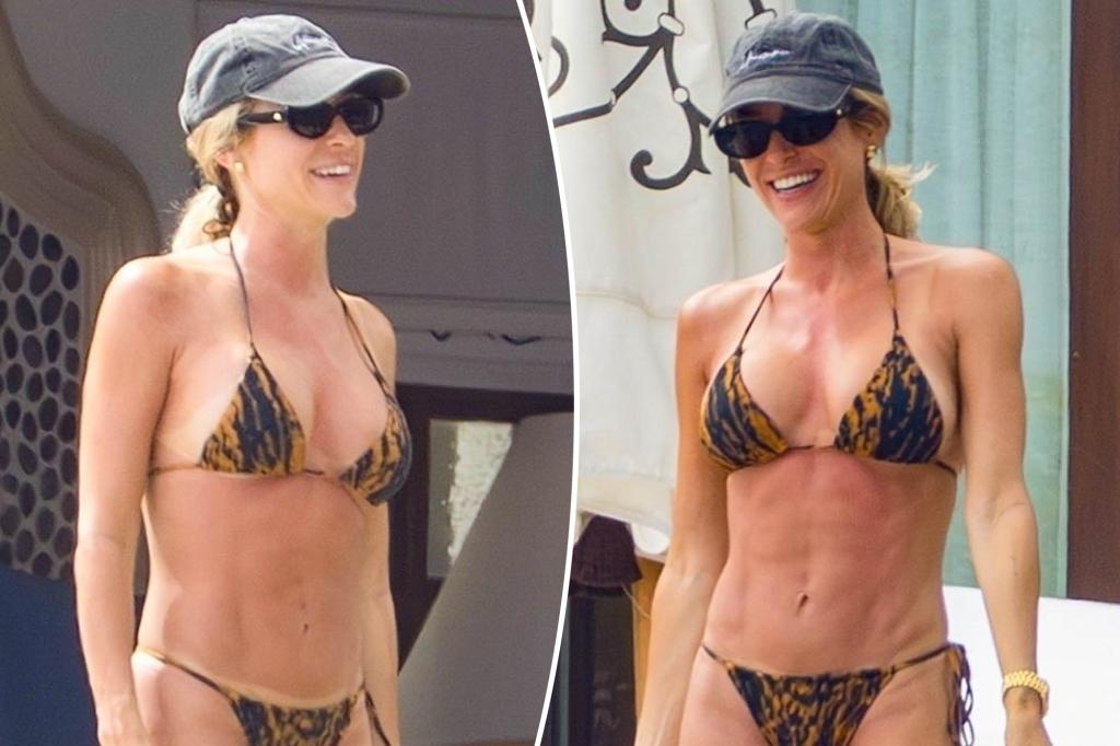 Kristin Cavallari shows off her new, larger breast implants in a tiger-print bikini during her vacation in Mexico.
