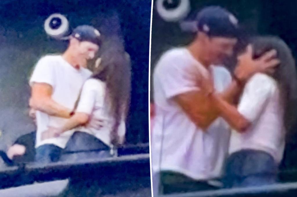 Mila Kunis and Ashton Kutcher display affection at Backstreet Boys concert