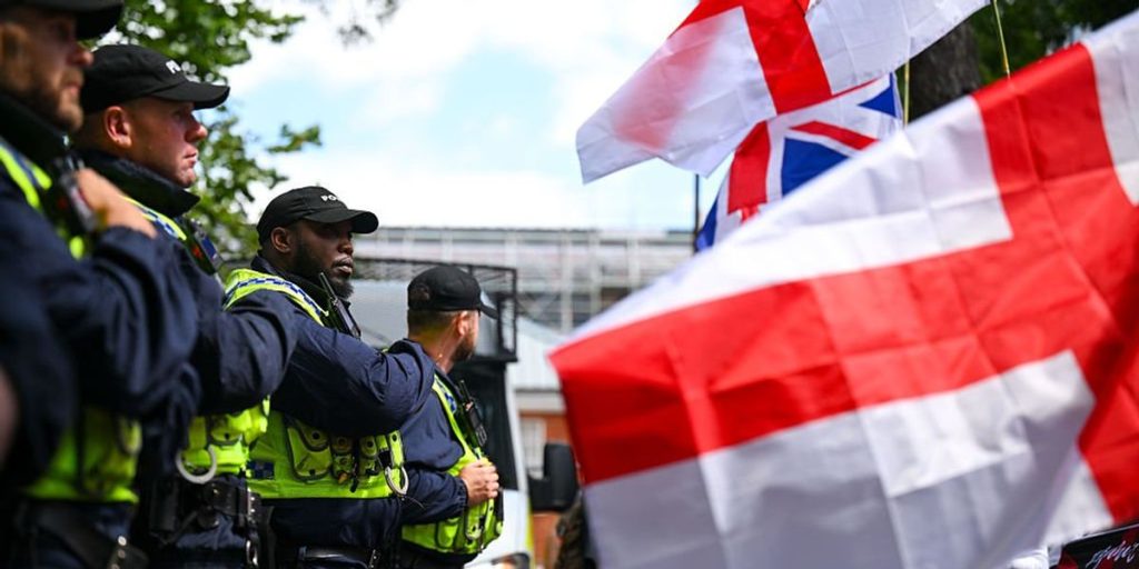 Police remove a man for expressing his fondness for bacon near a large mosque construction area.