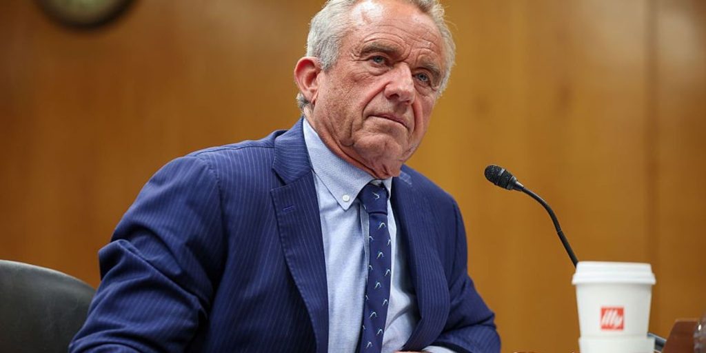RFK Jr. criticizes Biden's vaccine reporting rule and focuses on doctors' secret motivations.