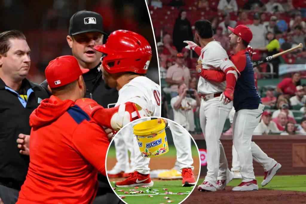 Willson Contreras of the Cardinals throws his bat at his coach during a wild ejection