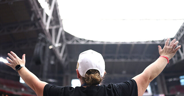 Crowd Members Take a Stand to Embrace Jesus as Their Savior at Charlie Kirk Memorial