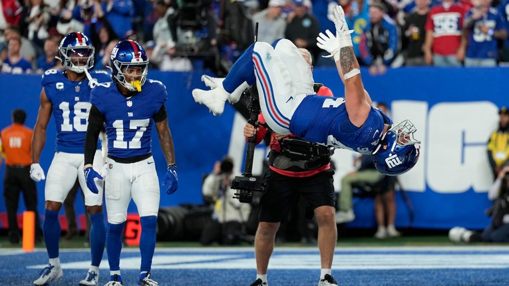 Giants' Cam Skattebo celebrates after his first home touchdown