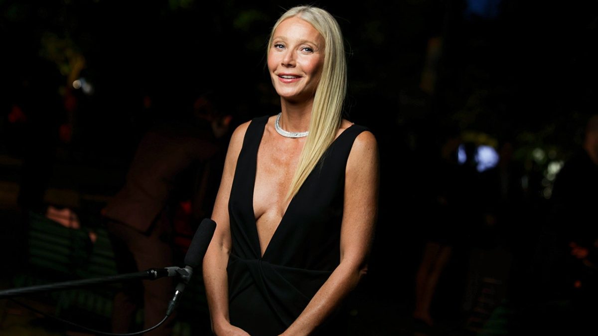 Gwyneth Paltrow shows off her blue bikini on the beach with her husband.