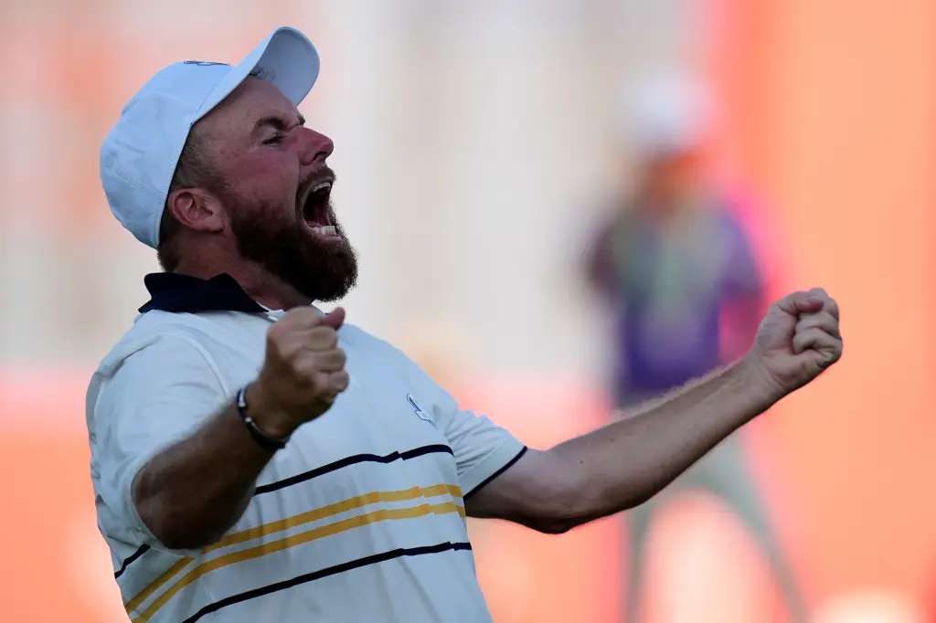 Shane Lowry, faced with hecklers at the Ryder Cup, celebrates as Team Europe secures victory.