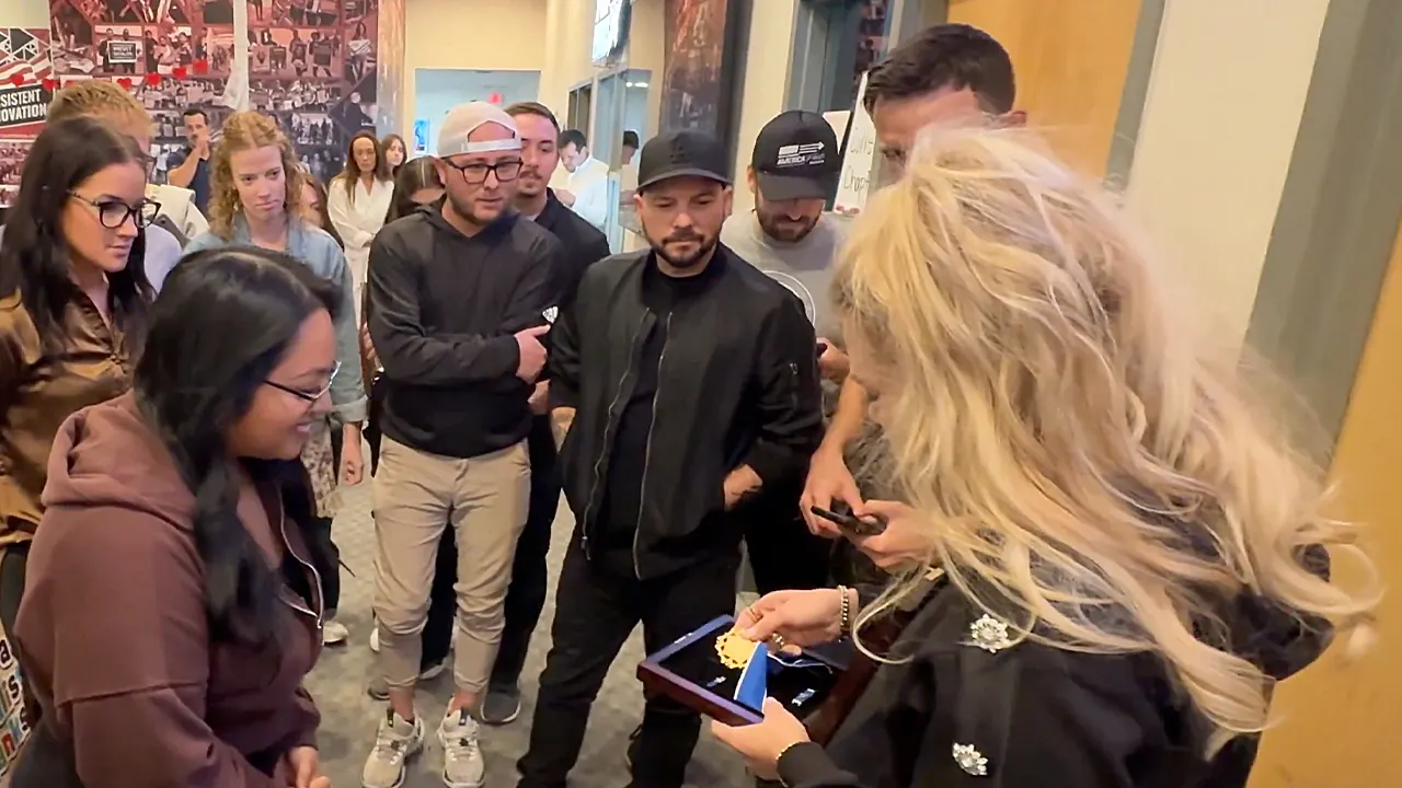 Erika Kirk displays Charlie Kirk's Medal of Freedom to Turning Point team.