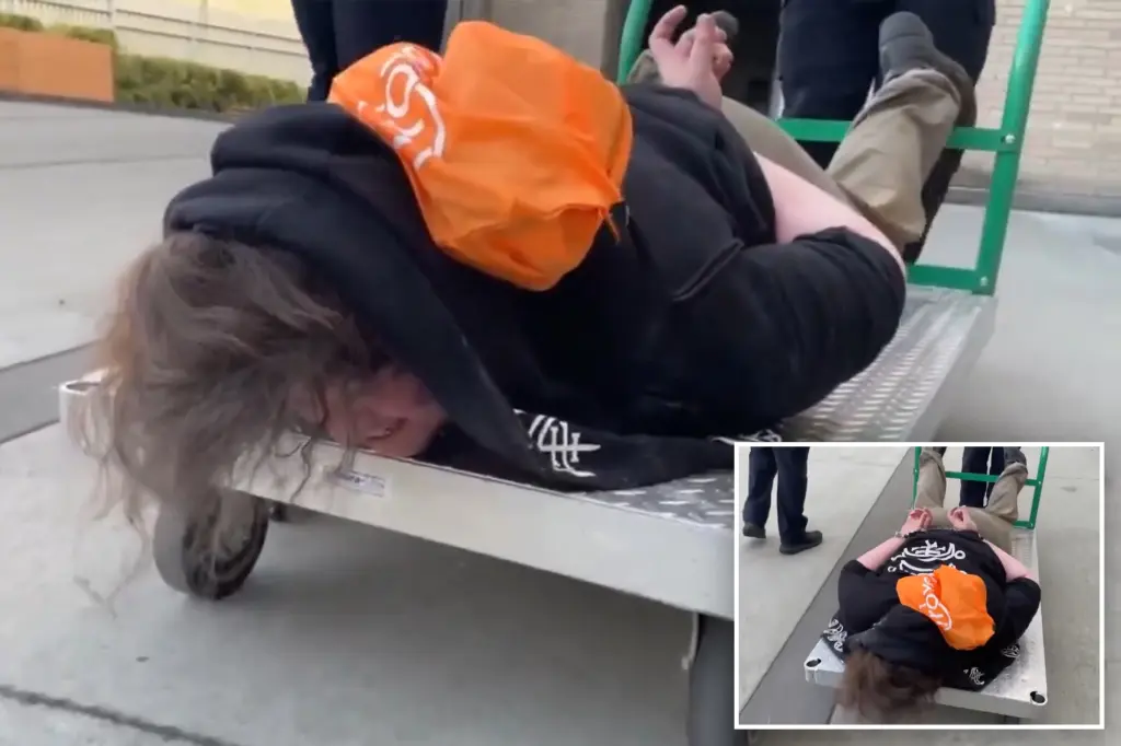 ICE shares widely viewed video of handcuffed Portland protester being taken away on flatbed cart