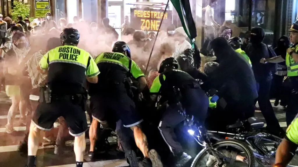 Protesters face disorder charges after violence injures police officers, officials say.