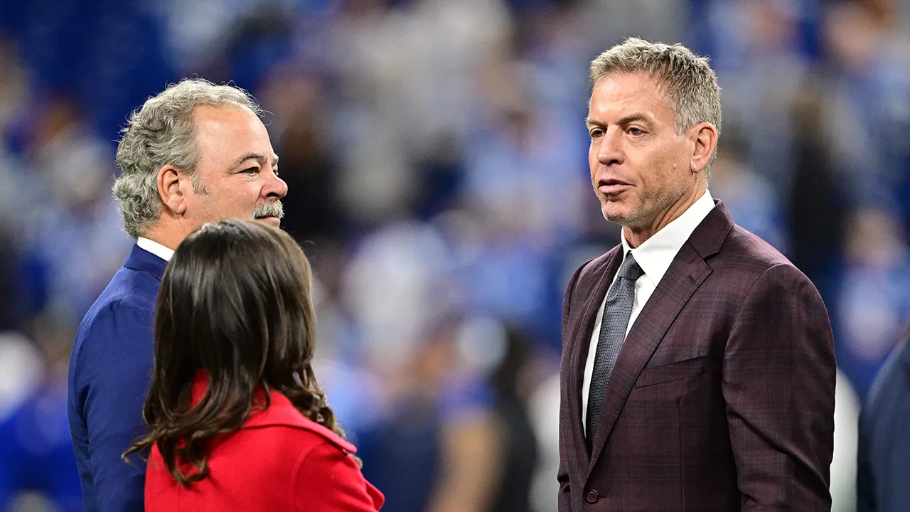 Former Cowboys player Troy Aikman jokes with Jerry Jones about a trade