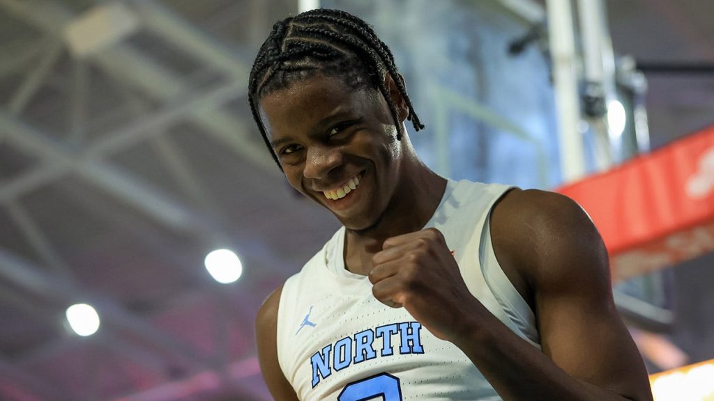 UNC's Caleb Wilson performs a dunk over a Michigan State player in NCAA basketball