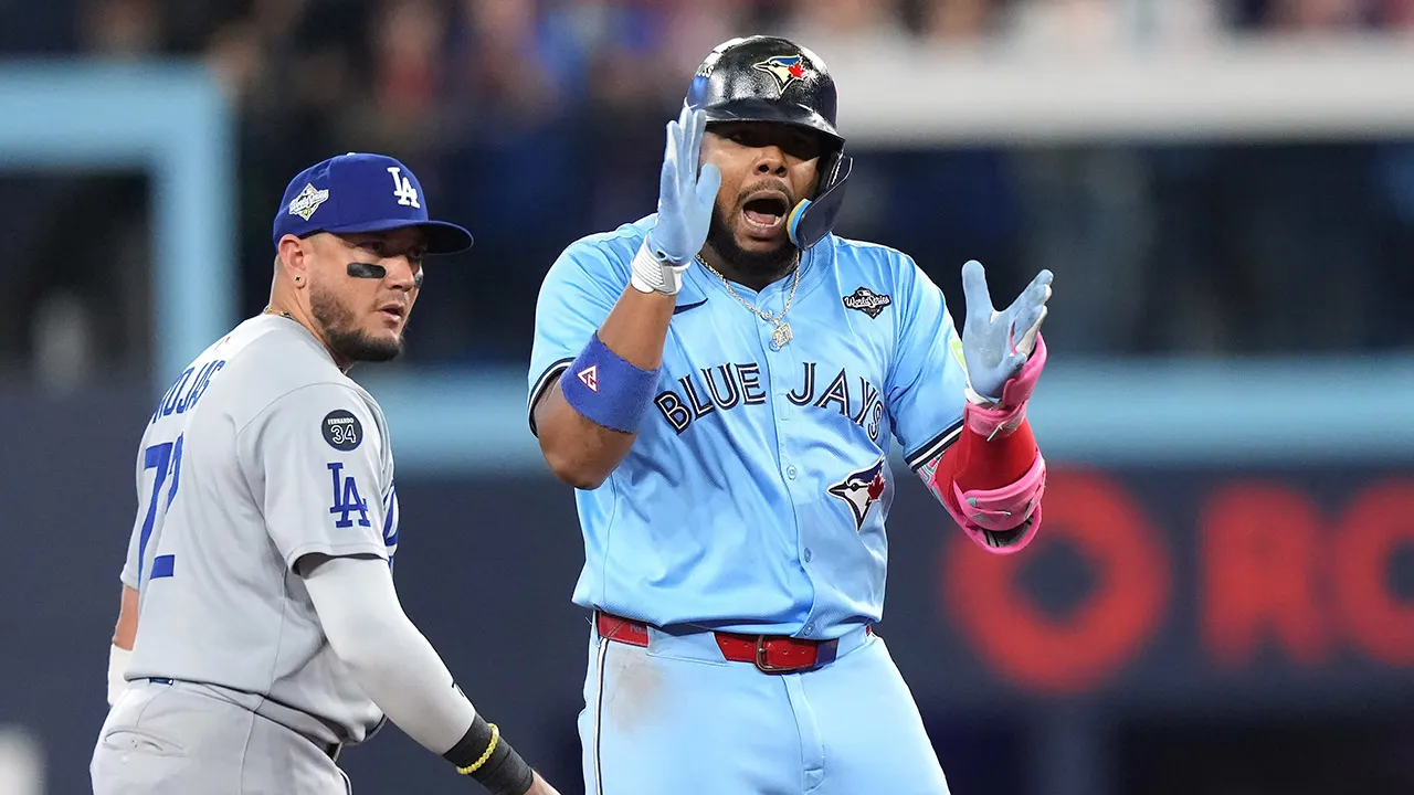 Vladimir Guerrero Jr dons a Marie-Philip Poulin jersey ahead of the World Series