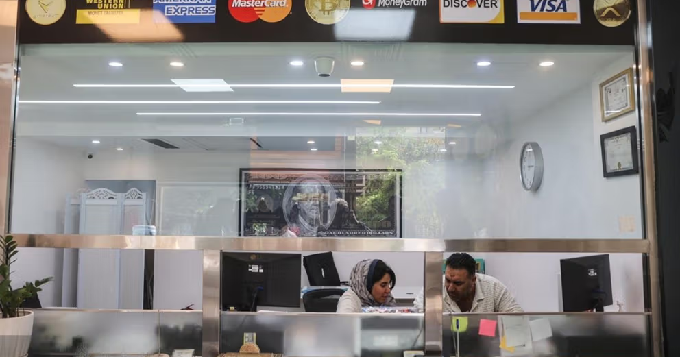 Iran's currency falls to new lows as the dollar exceeds 1.28 million rials