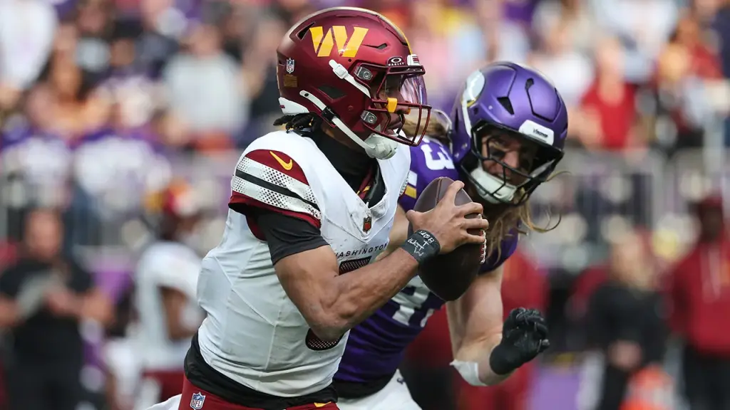 Jayden Daniels of the Commanders exits the game following a hit