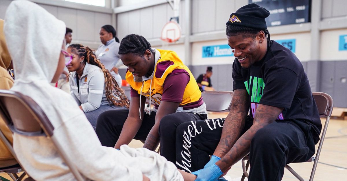 Ravens Players Demonstrate Jesus' Leadership by Washing the Feet of Schoolchildren