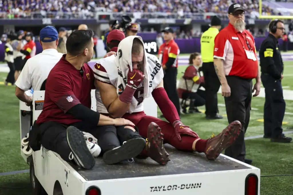 Zach Ertz of the Commanders is believed to have a torn ACL after being hit.