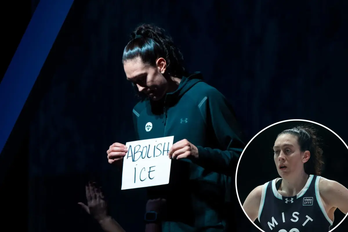 Breanna Stewart from the Liberty holds a sign advocating for the abolition of ICE prior to the Unrivaled game.