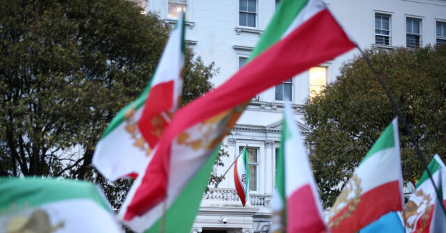 Demonstrator Raises Pre-Islamic Revolution Iran Flag at London Embassy