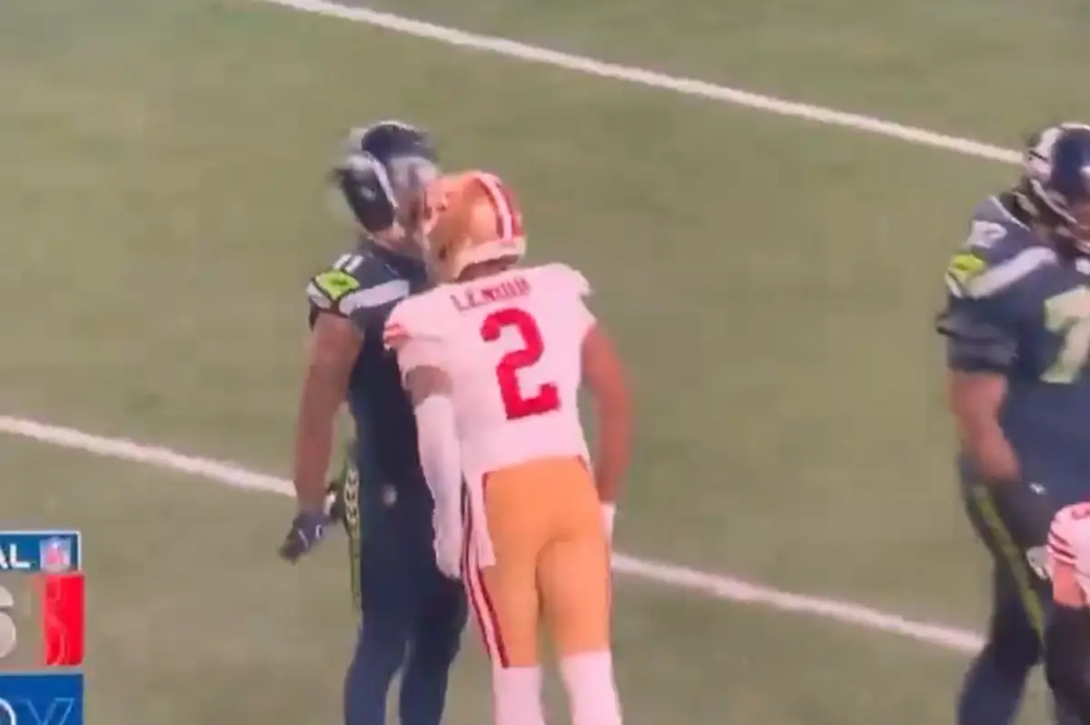 Deommodore Lenoir of the 49ers headbutts Jaxon Smith-Njigba of the Seahawks