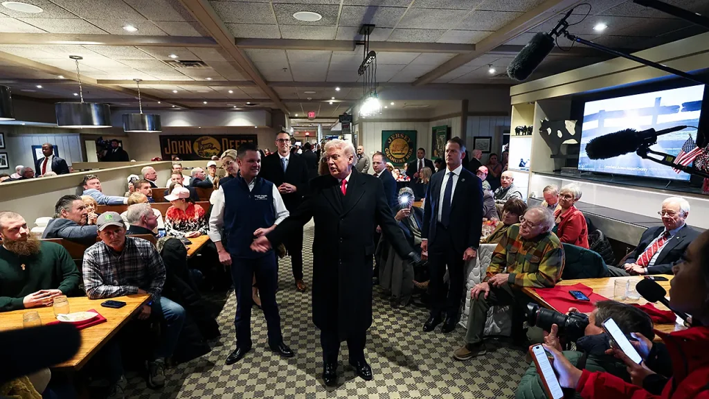 Donald Trump is prayed for by a diner in Iowa