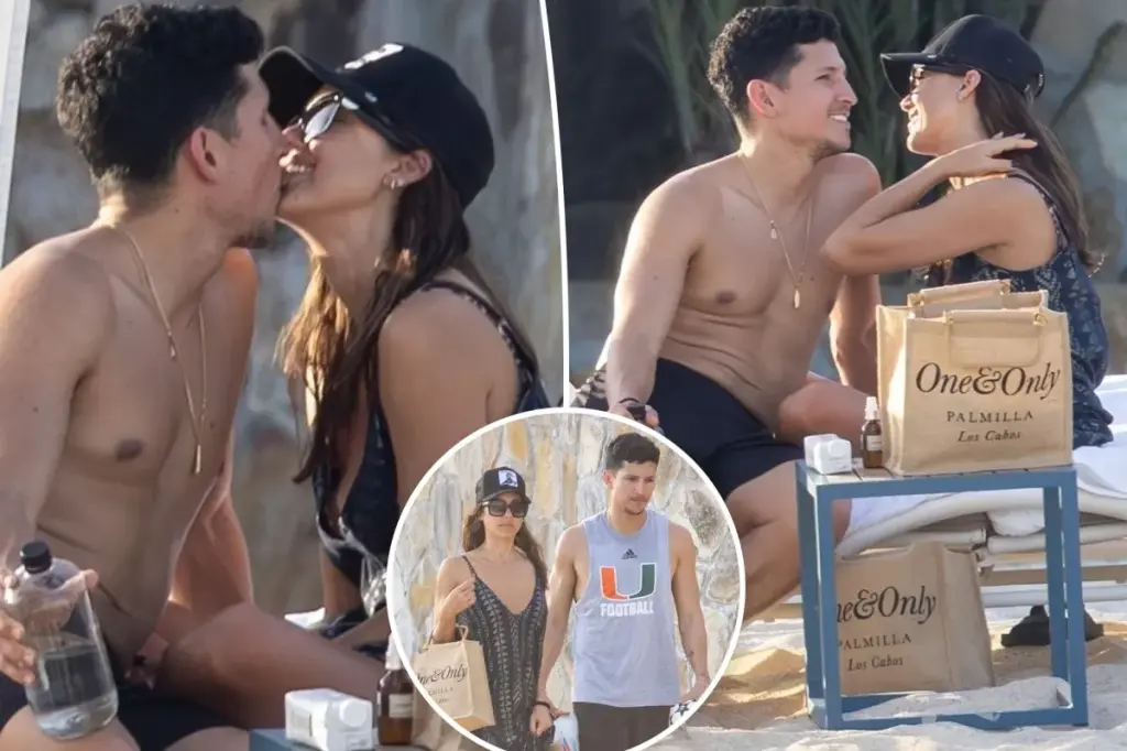 Jessica Alba and Danny Ramirez share a kiss while on vacation at a beach in Mexico.