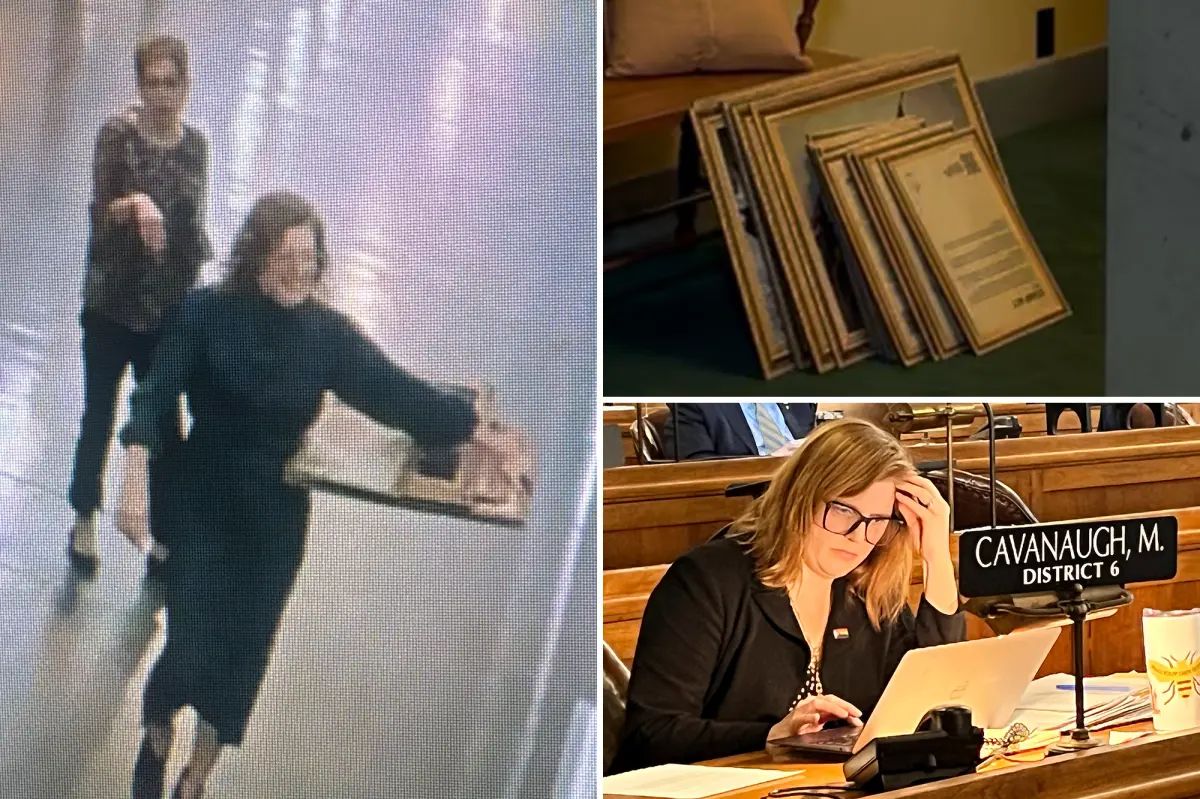 Nebraska state Senator Machaela Cavanaugh seen taking down portraits of the founding fathers from the Capitol