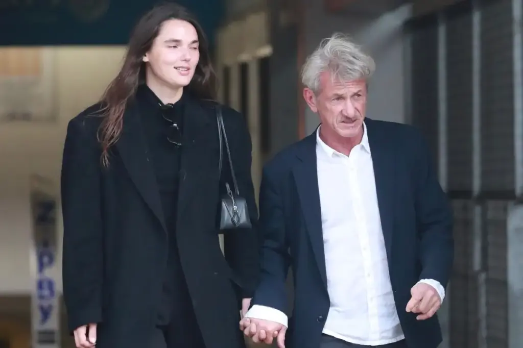 Sean Penn, 65, and his 30-year-old girlfriend share a hand-holding moment during a rare public appearance after the Golden Globes.
