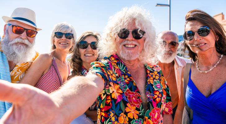 The retirement savings required for a monthly spending of $10,000 at ages 55, 62, and 65, and the reasons for the significant variations.