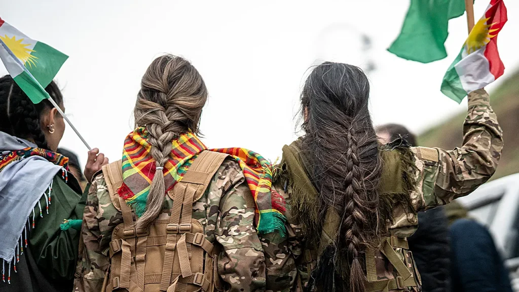 Video shows Syrian fighter with braid he says is from a Kurdish woman in Raqqa.